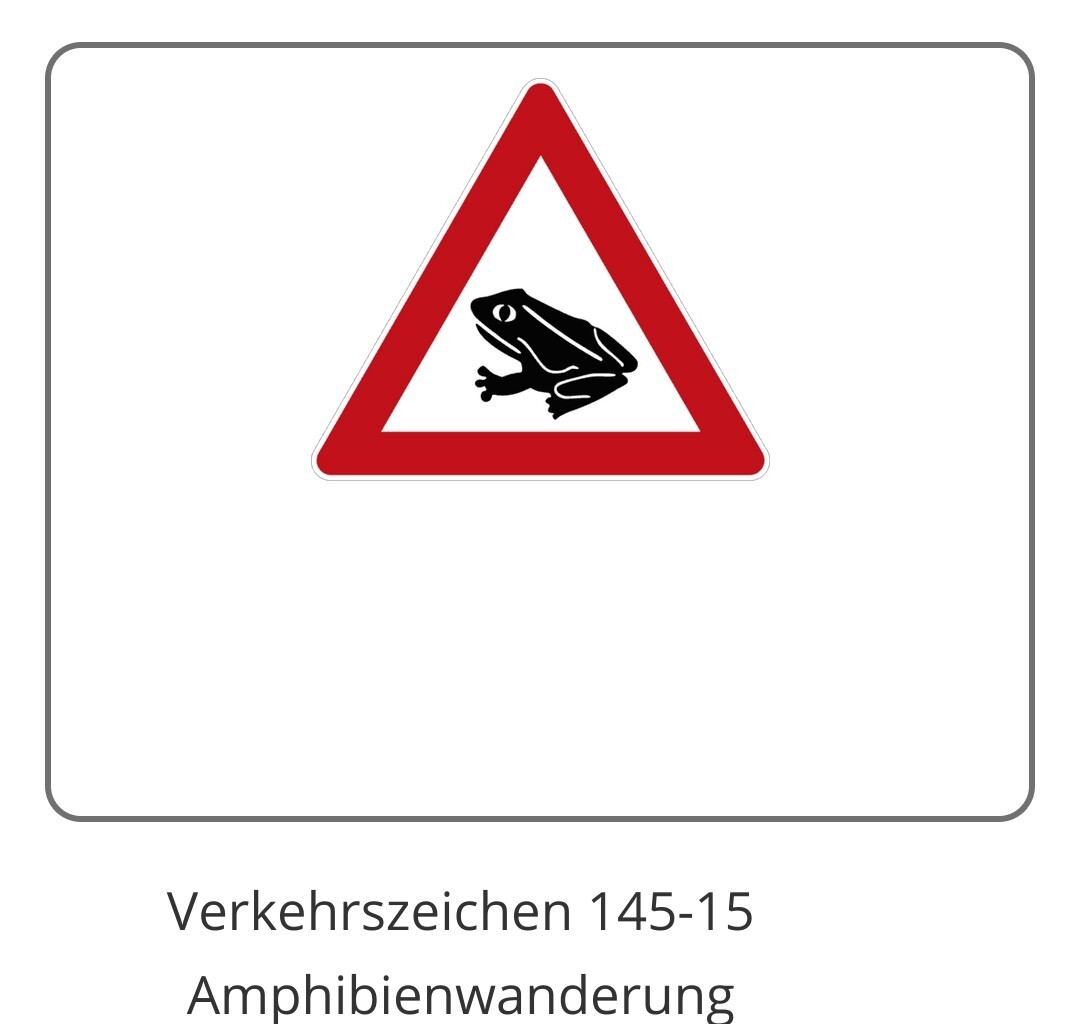 Das Verkehrszeichen 145-15 bedeutet Amphibienwanderung. Ein dreieckiges weißes Schild mit rotem Rand in dessen Mitte eine schwarze Kröte abgebildet ist.