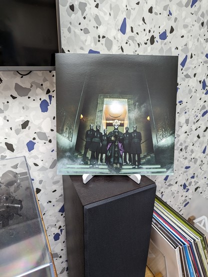 Photo of the inner sleeve of Meliora by Ghost, which shows Papa and the Ghouls standing in a dramatic museum-like building