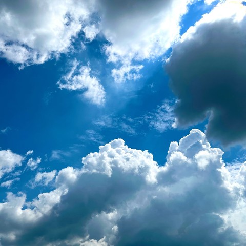 Image of the blue sky and massive clouds, high contrast.