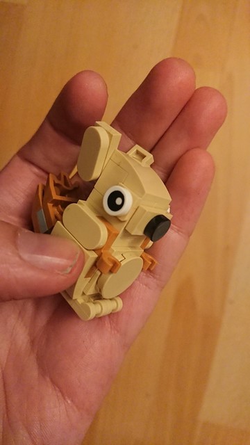 A squirrel built from Lego bricks in the palm of a hand