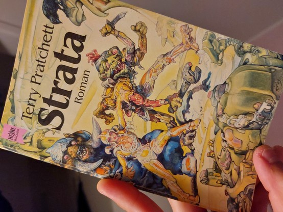 Picture shows a science fiction novel written by Terry Pratchett named 'Strata'.