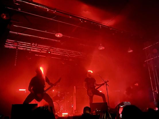 CELESTE on stage with red lighting. The band were all wearing red head torches too. Blurred action shot.