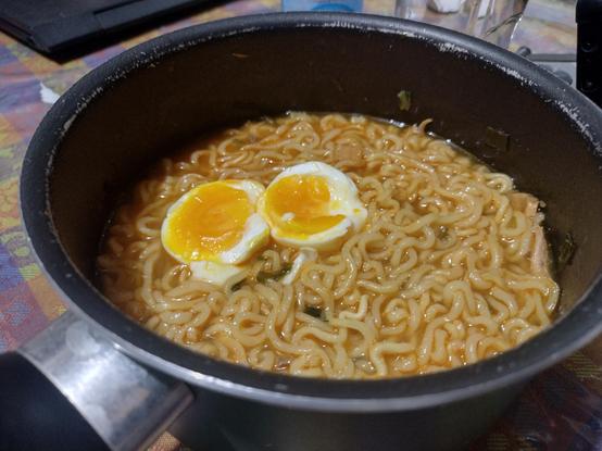 small sauce pan with instant ramen topped with soft boiled eggs