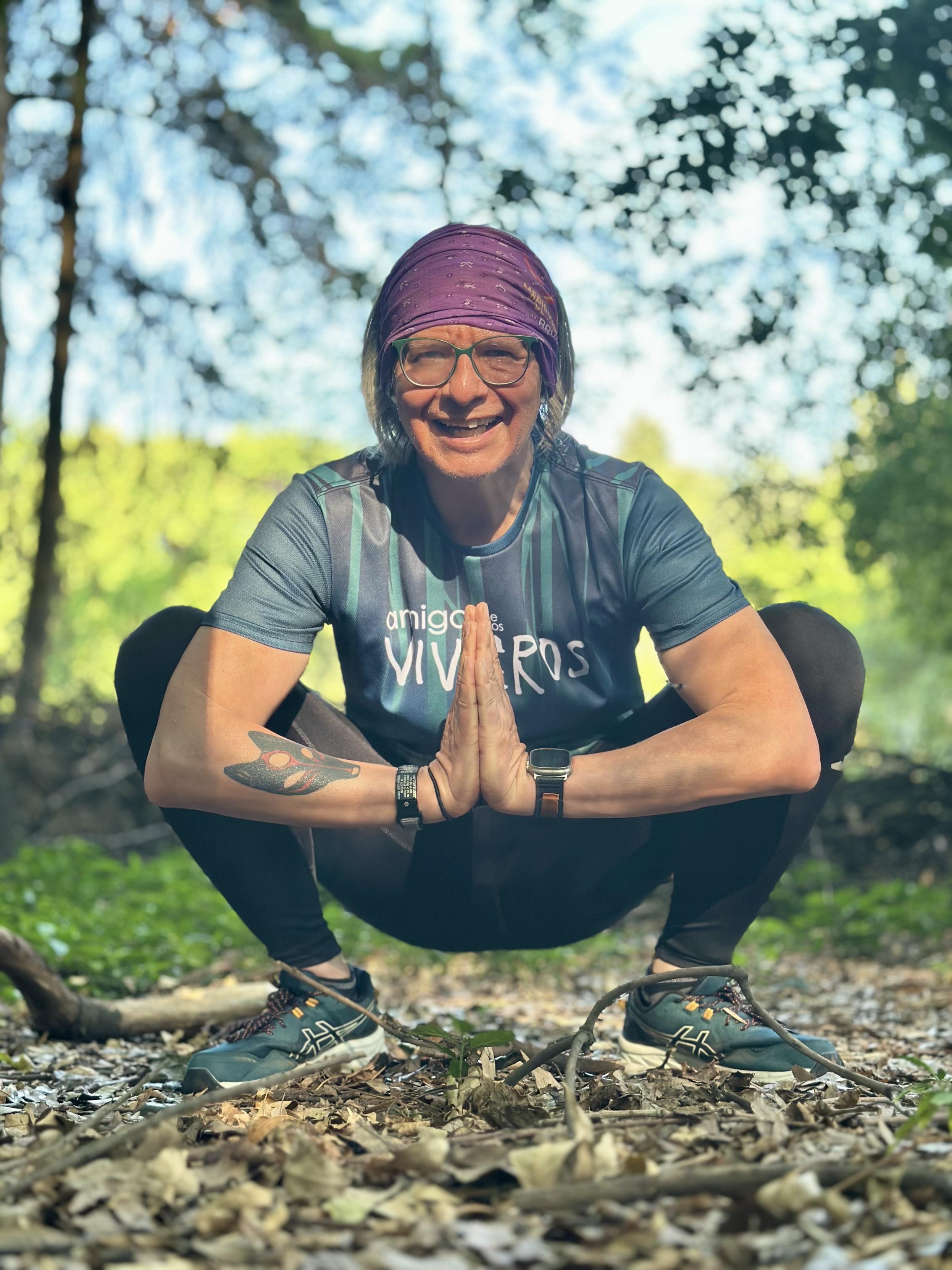 Squatting before the camera after a 10k run among the trees.
