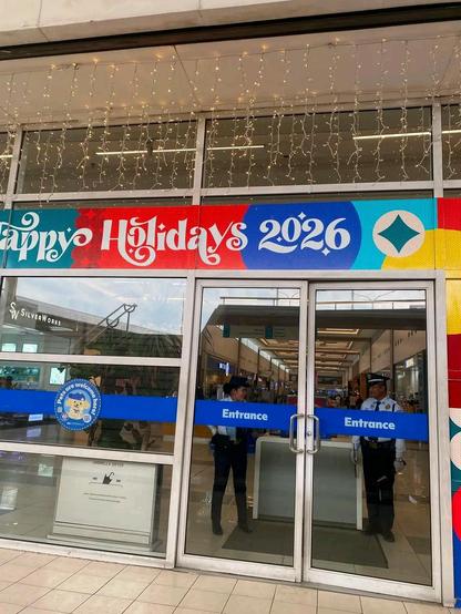 "Happy Holidays 2026" banner above a mall entrance
